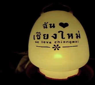 a yellow lantern that says: We Love Chiang Mai in English and Thai
